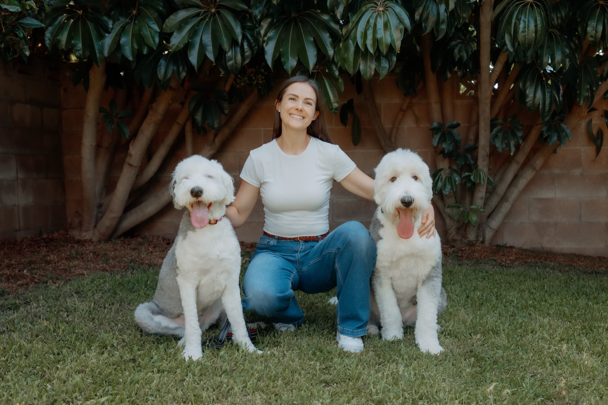 Kendall outdoors with two trained dogs