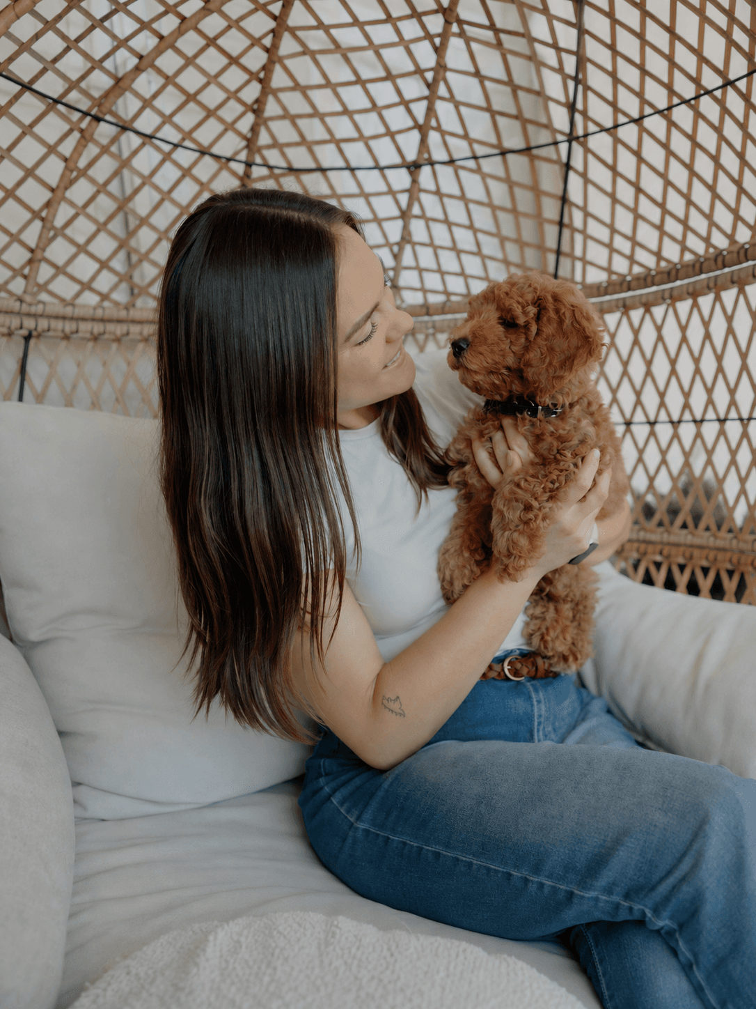 Kendall sharing a quiet moment with a brown puppy